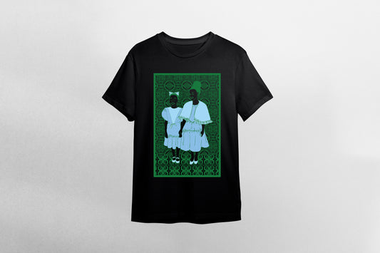 A black short-sleeve crewneck t-shirt featuring a rectangular graphic print on the front. The graphic depicts two young black children in light blue sunday dresses standing against a dark green african patterned background.